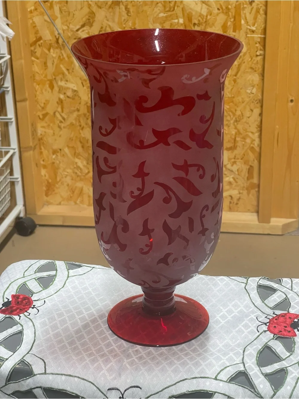 Large Ruby red tall pedestal etched 12” vase, , has a tiny chip, hardly noticeab